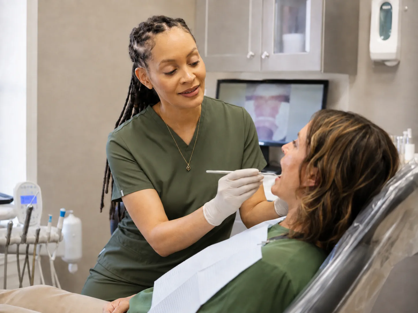 Dr. Paris Little examining a patient in the operatory at Clarity Dental in McDonough, Georgia