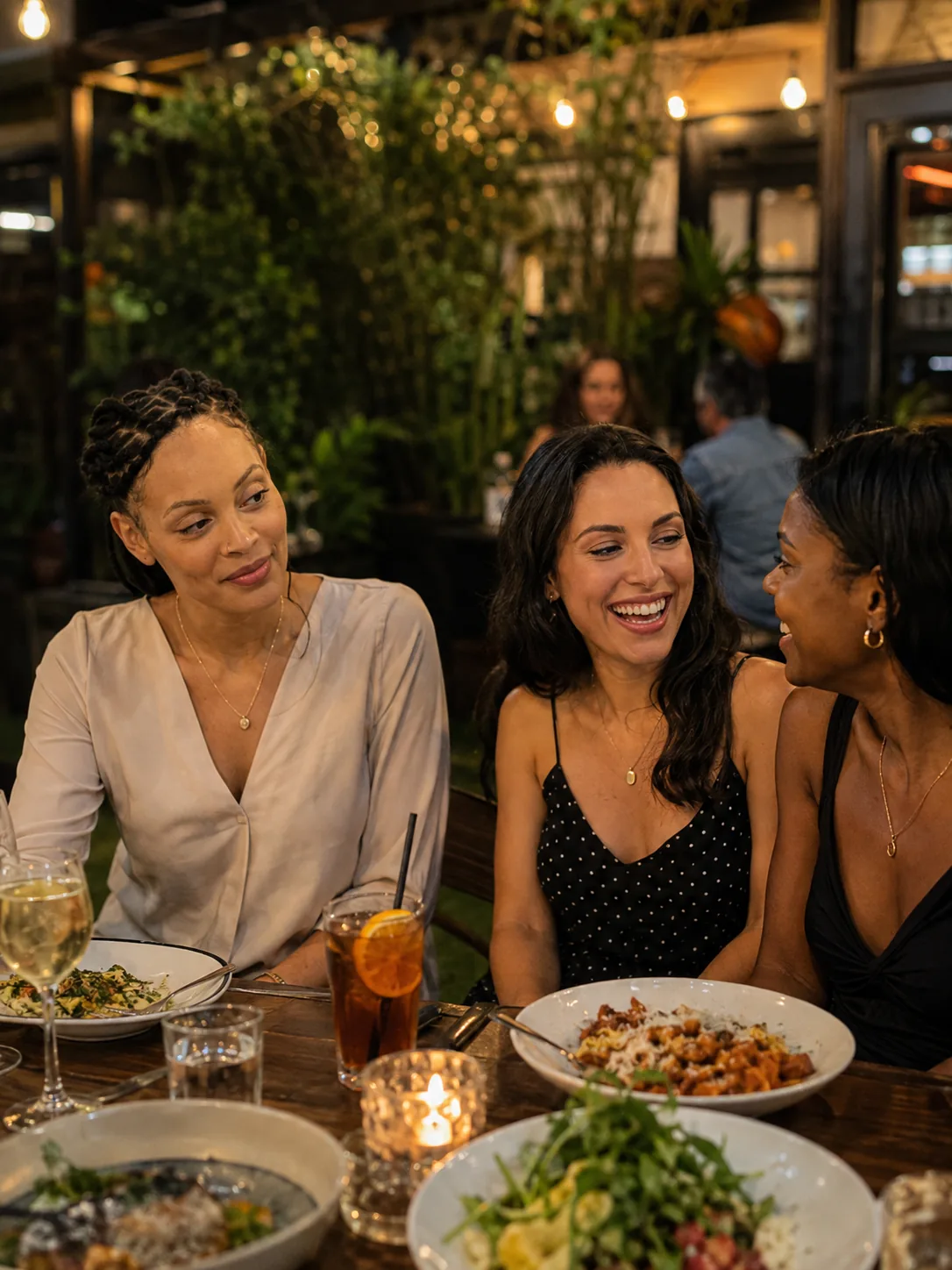 Dr. Paris Little laughing over dinner with friends