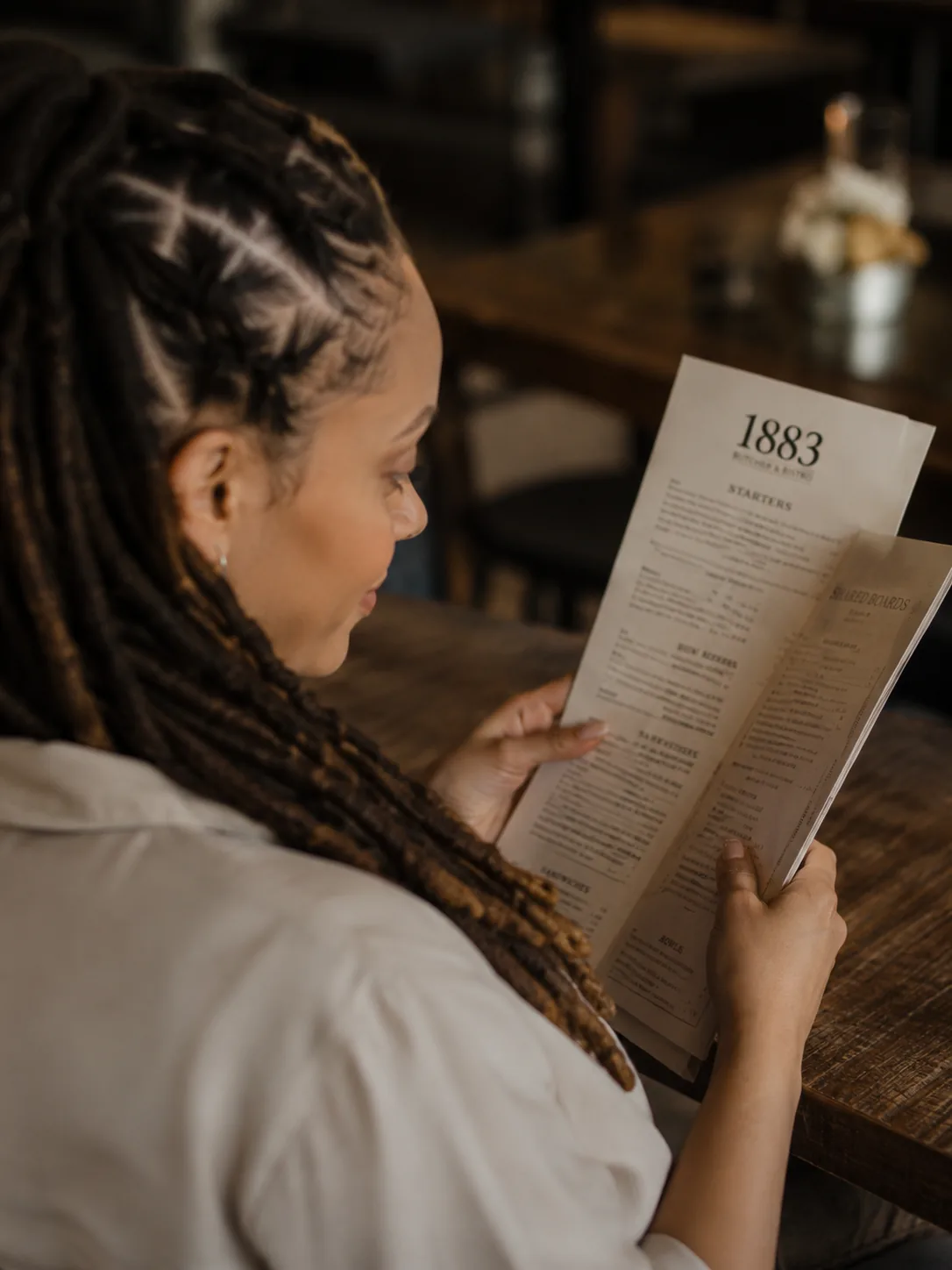 Dr. Paris Little reading the menu at a downtown McDonough restaurant
