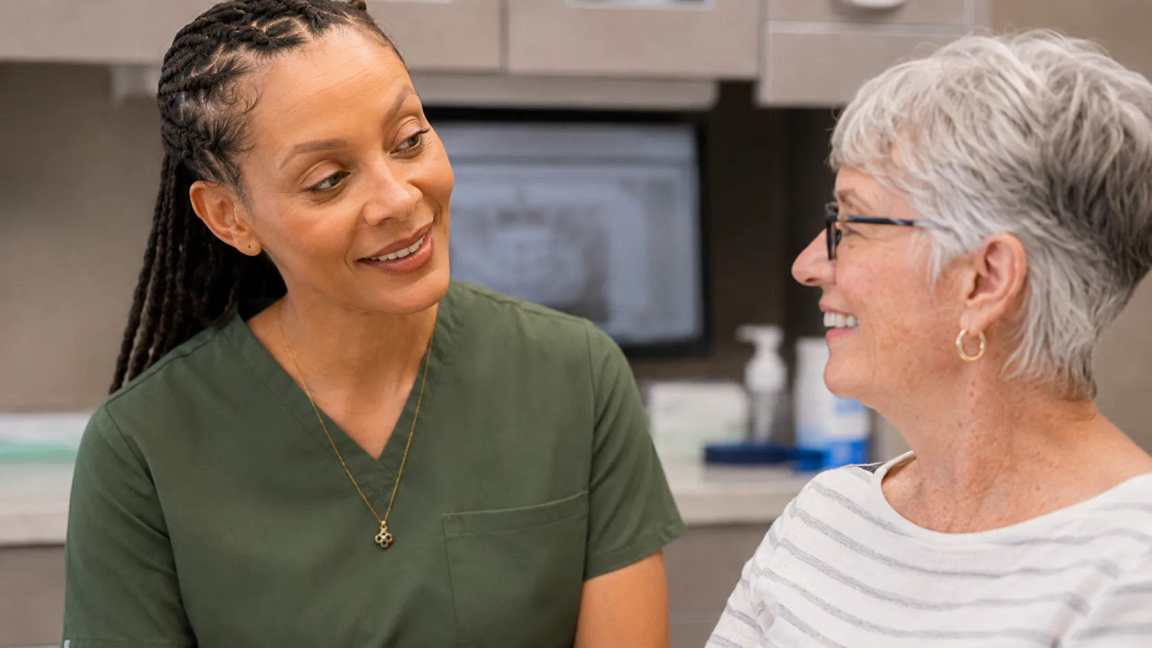 Dr. Paris Little in conversation with a senior patient at Clarity Dental in McDonough, Georgia