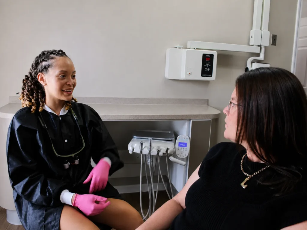 Dr. Paris Little smiling with a patient during a visit at Clarity Dental in McDonough, Georgia