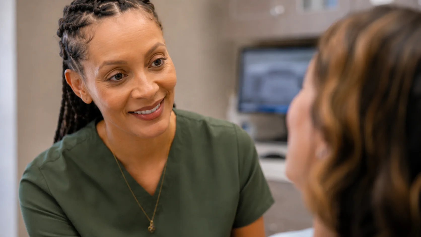 Dr. Paris Little sharing a smile with a patient at Clarity Dental in McDonough, Georgia