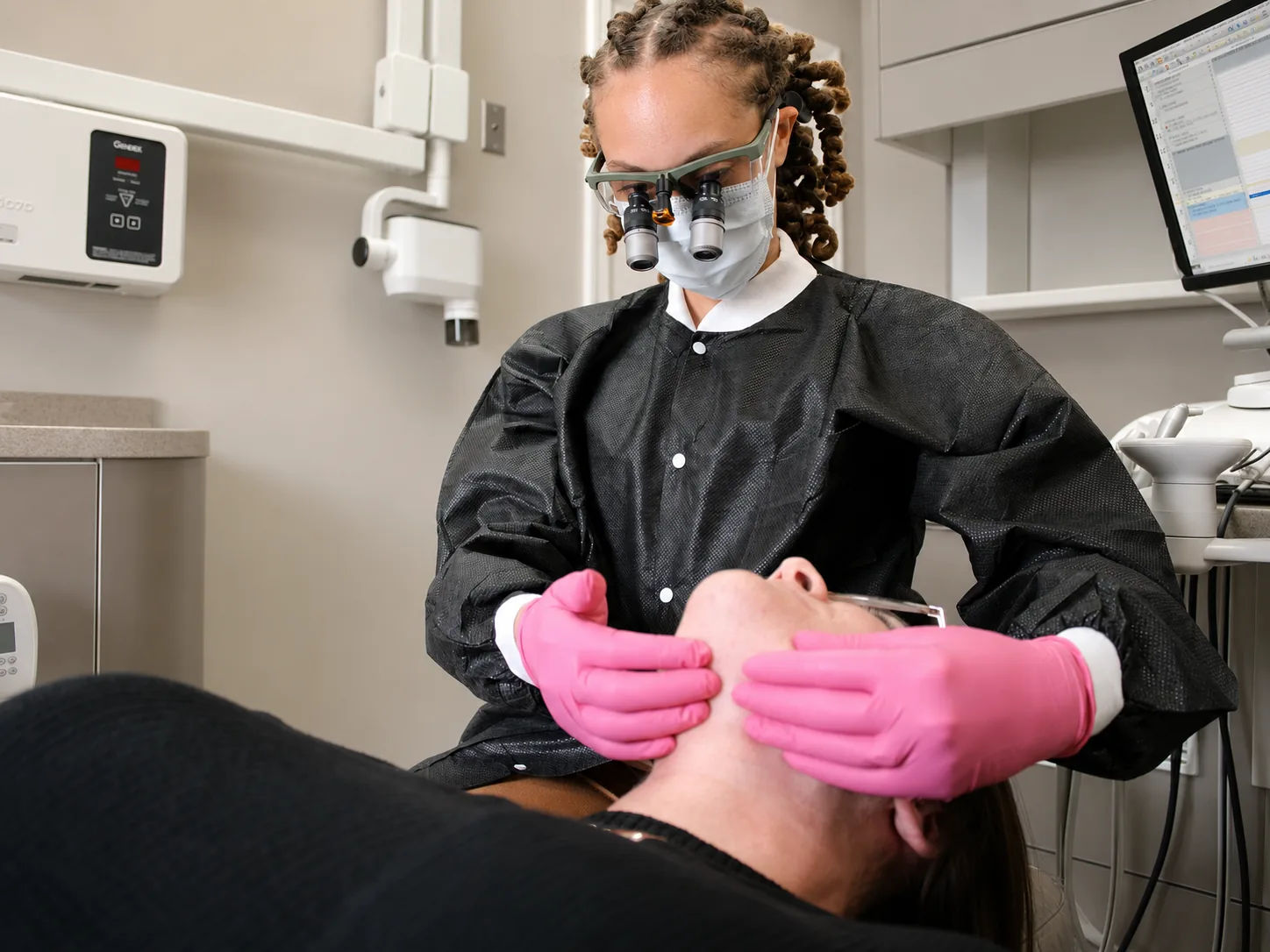 Dr. Paris Little performing a gentle jaw exam at Clarity Dental in McDonough, Georgia