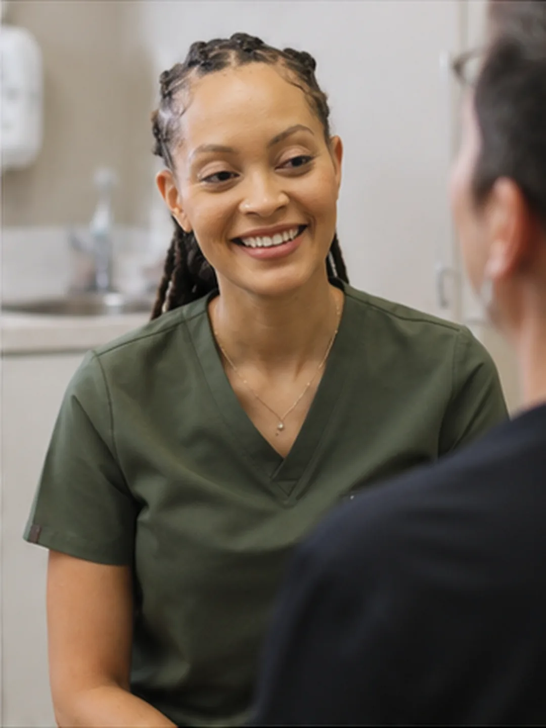 Dr. Paris Little smiling with a patient during a consultation at Clarity Dental in McDonough, Georgia