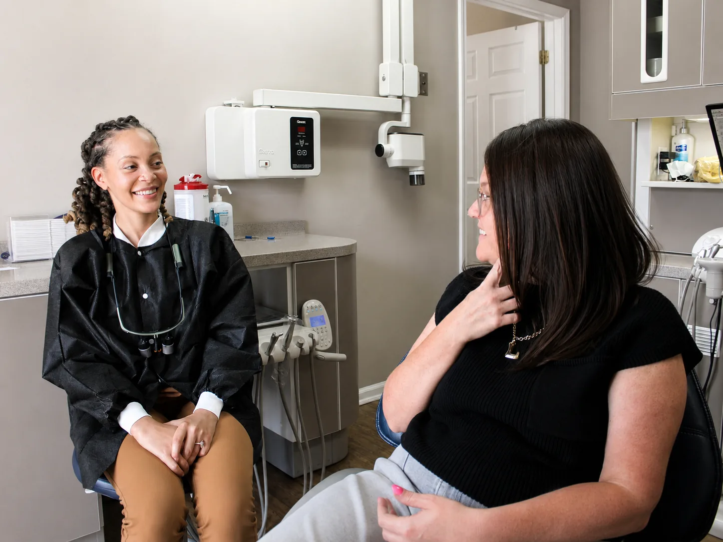 A patient asking Dr. Paris Little a question during a visit at Clarity Dental in McDonough, Georgia