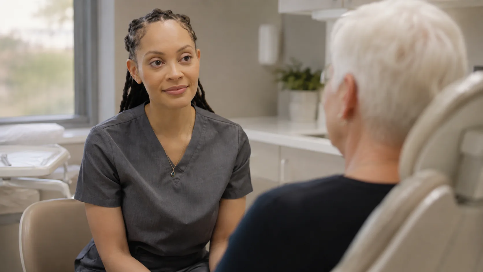 Dr. Paris Little in an unhurried conversation with a patient at Clarity Dental in McDonough, Georgia