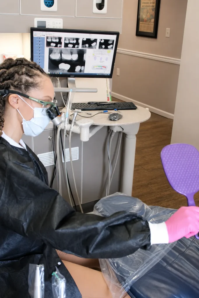 Dr. Paris Little working chairside with digital X-rays on screen at Clarity Dental in McDonough, Georgia