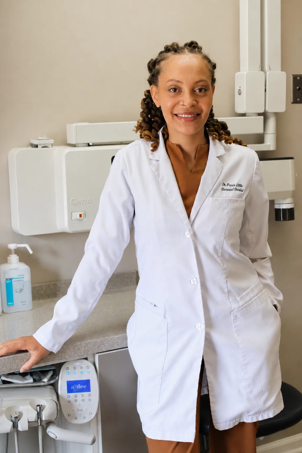 Portrait of Dr. Paris Little in a white coat in the operatory at Clarity Dental in McDonough, Georgia