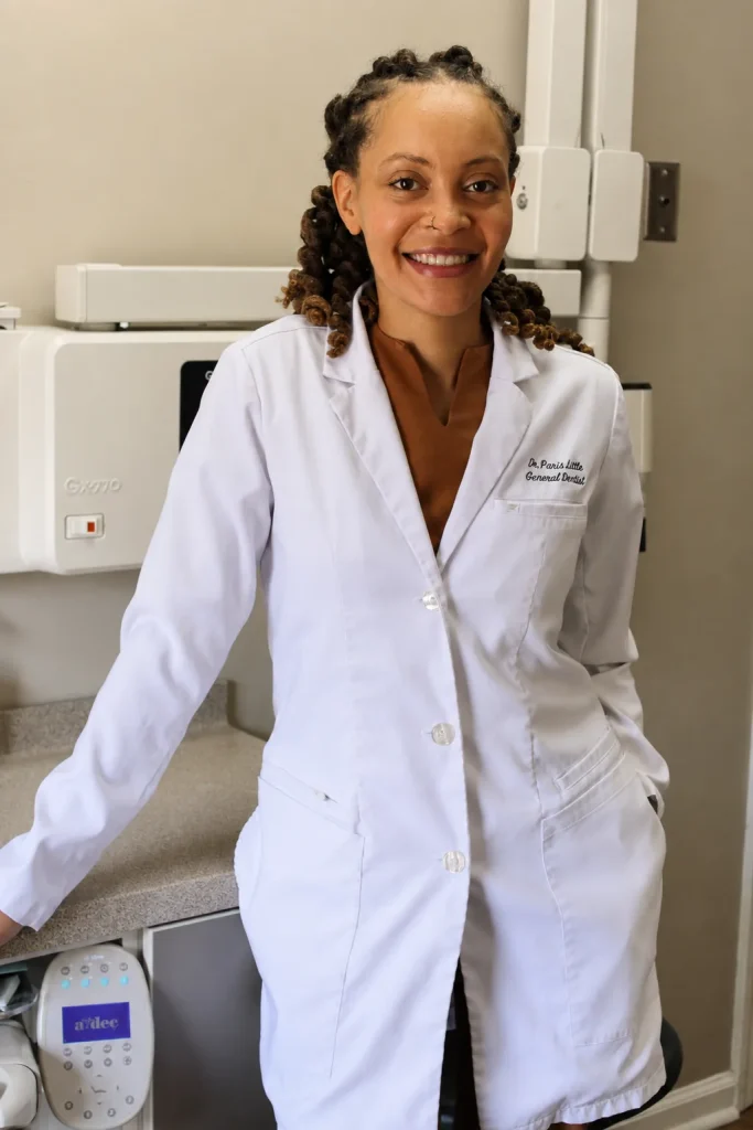 Dr. Paris Little smiling in a white coat at Clarity Dental in McDonough, Georgia