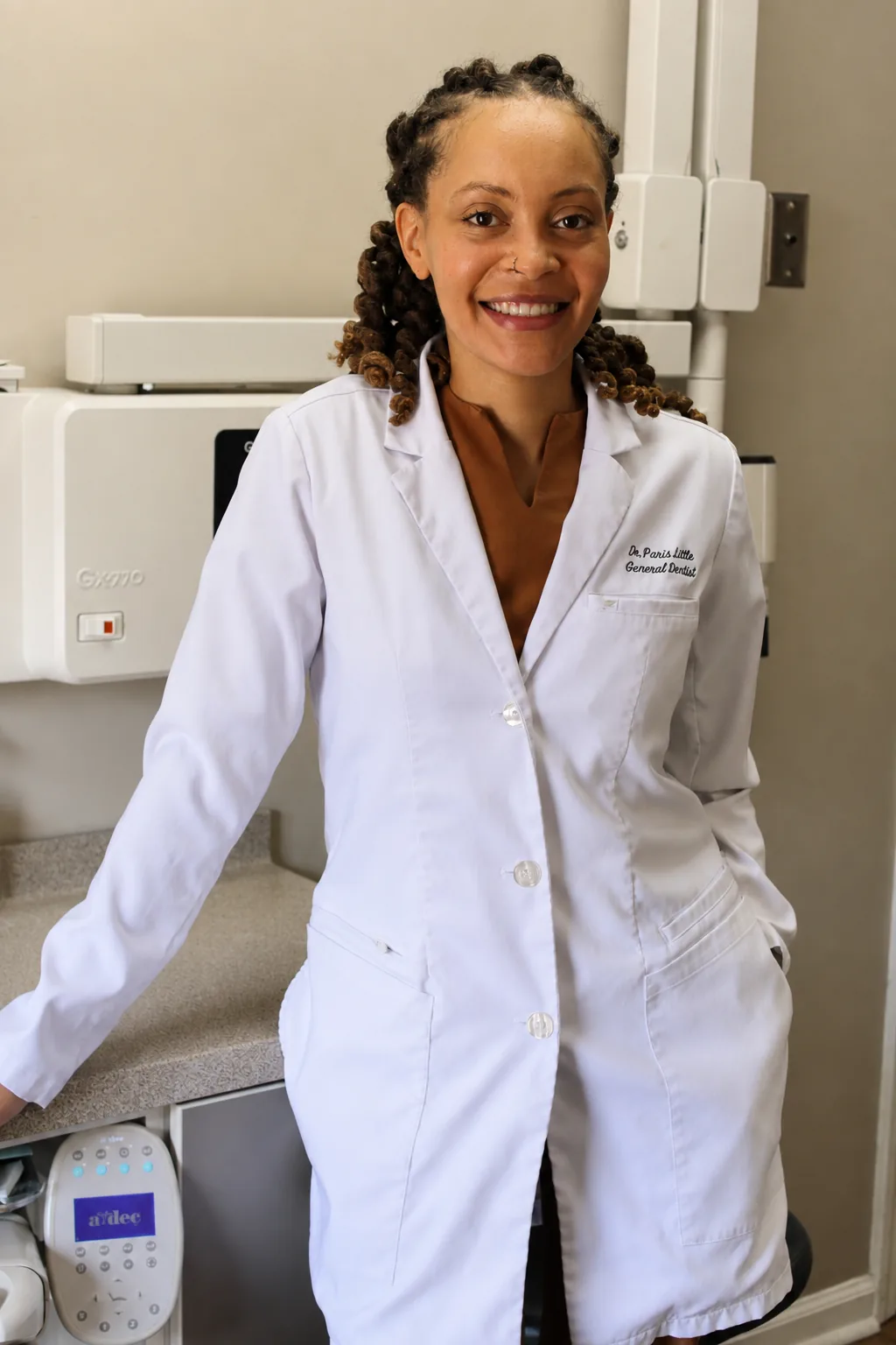 Dr. Paris Little smiling in a white coat at Clarity Dental in McDonough, Georgia